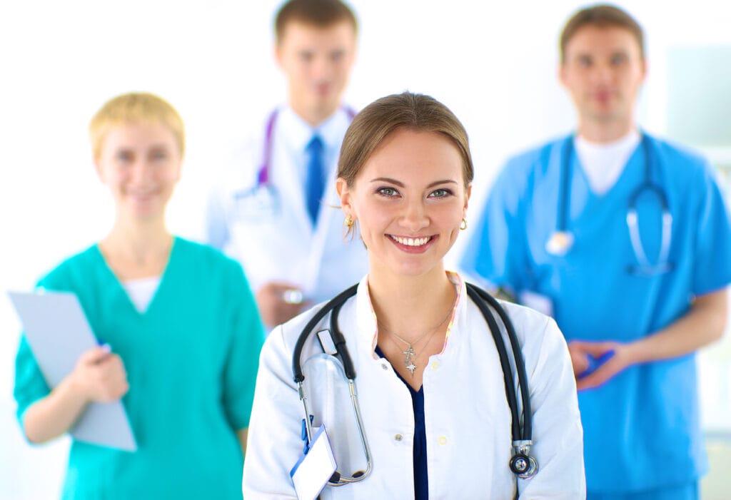 Attractive female doctor in front of medical group